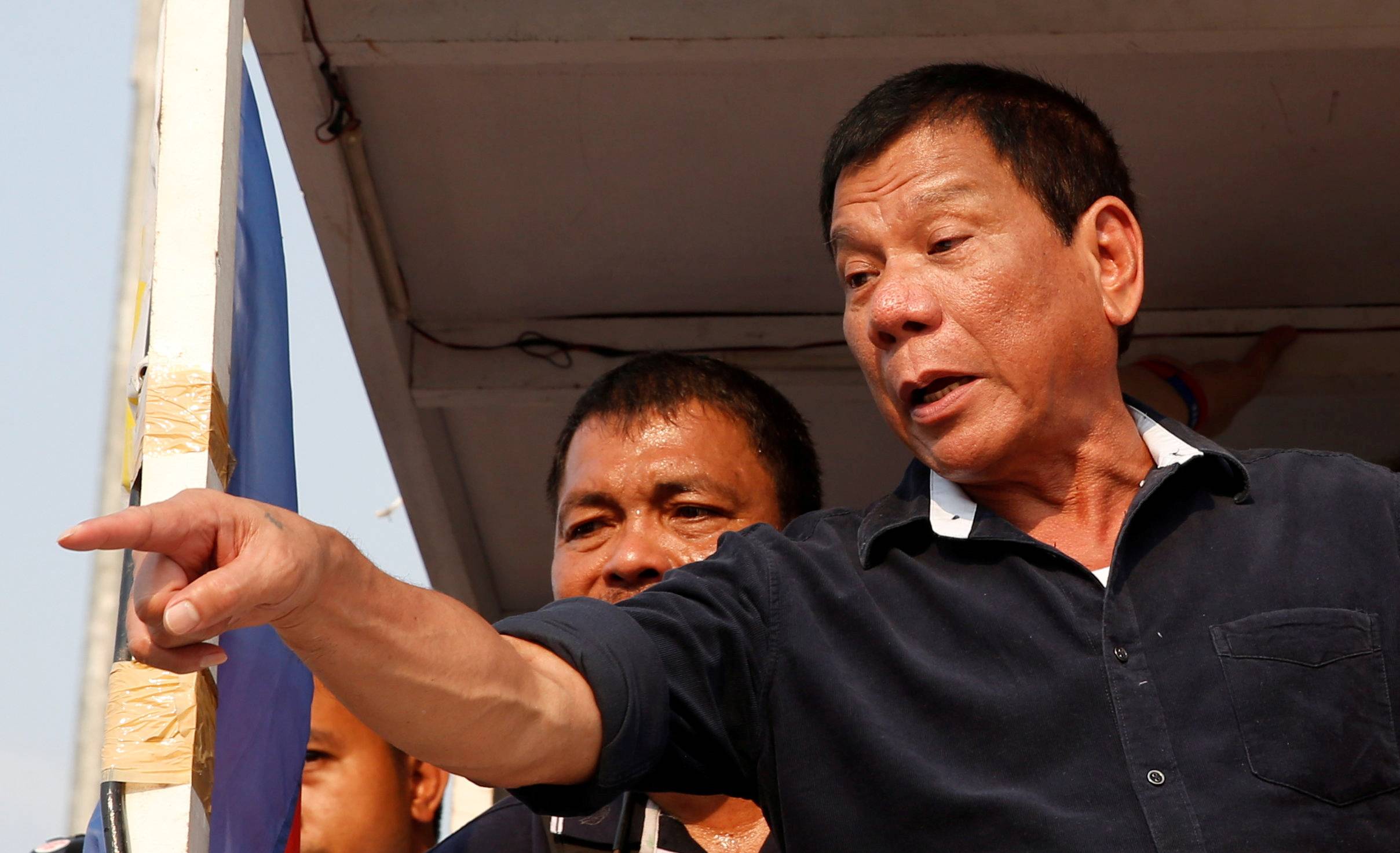 FILE PHOTO: Presidential candidate Rodrigo "Digong" Duterte greets supporters during election campaigning in Malabon, Metro Manila