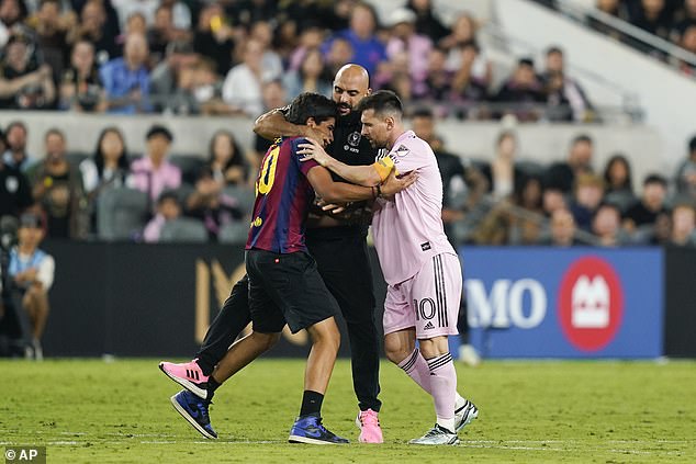 Photos: Messi's bodyguard grabs invader by NECK