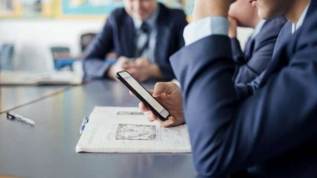 Mobile phones are to be banned in UK schools