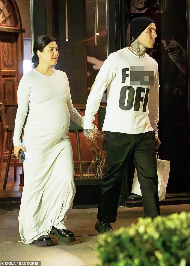 Kourtney Kardashian displays her HUGE baby bump as she steps out with husband