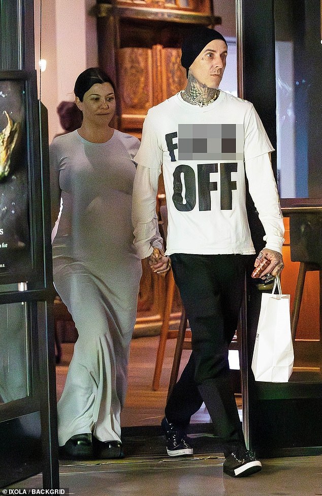 Kourtney Kardashian displays her HUGE baby bump as she steps out with husband