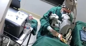 Shocking moment doctor PUNCHES patient in the face while performing surgery on her eyes Shocking moment doctor PUNCHES patient in the face while performing surgery on her eyes