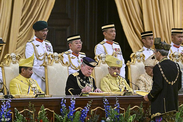 Malaysia crowns its new BILLIONAIRE king, who owns 300 luxury cars, fleet of private jets and his own ARMY