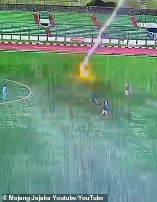 Terrifying moment footballer is struck by lightning during a match