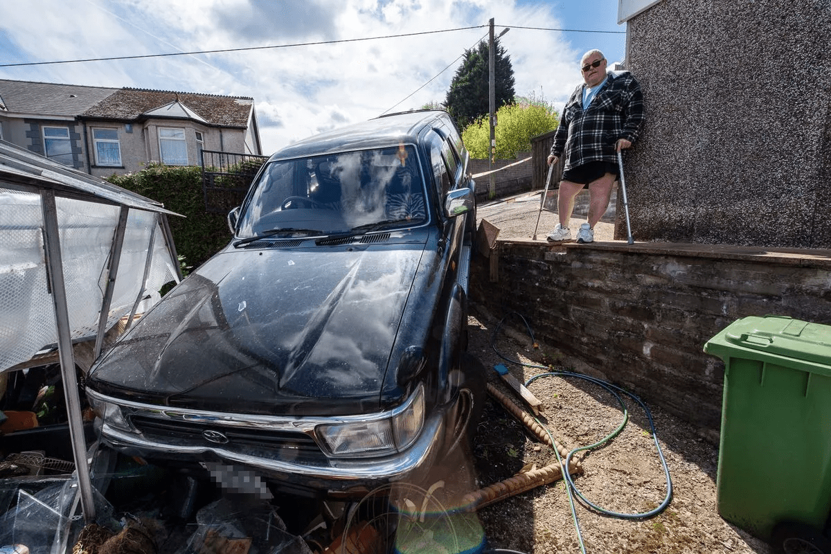 Crashed 4x4 left hanging over couple's garden