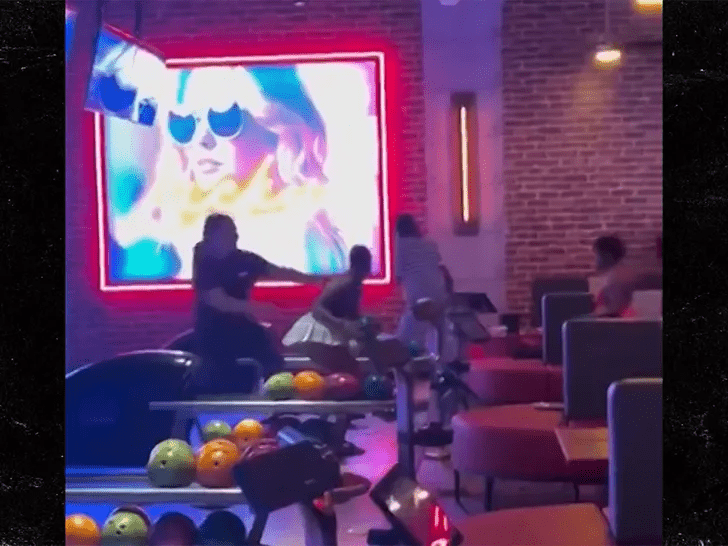 Woman throws bowling ball in fight