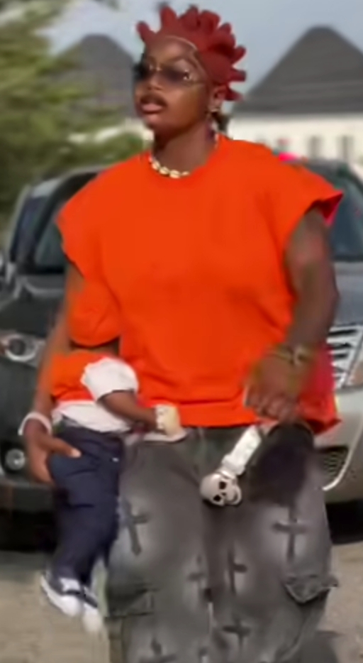 Black Chully receives backlash for holding baby in a strange manner Black Chully receives backlash for holding baby in a strange manner