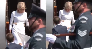 Macron’s wife rejects his help as they get off plane Macron's wife rejects his help as they get off plane