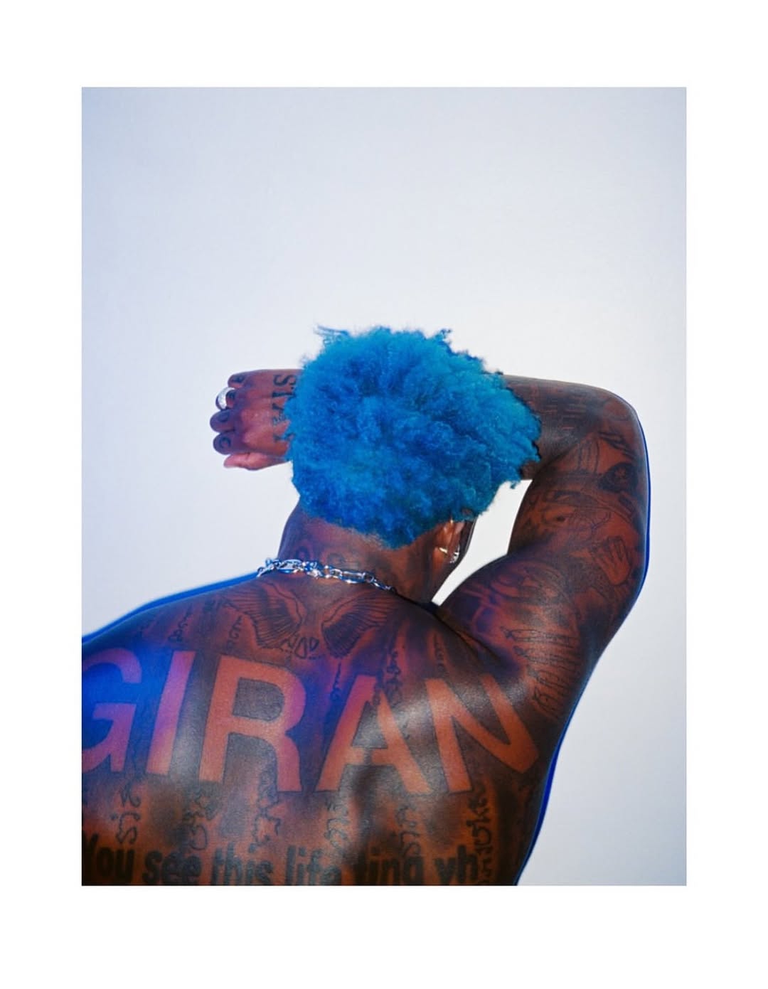Asake flaunts extensive tattoos and muscle